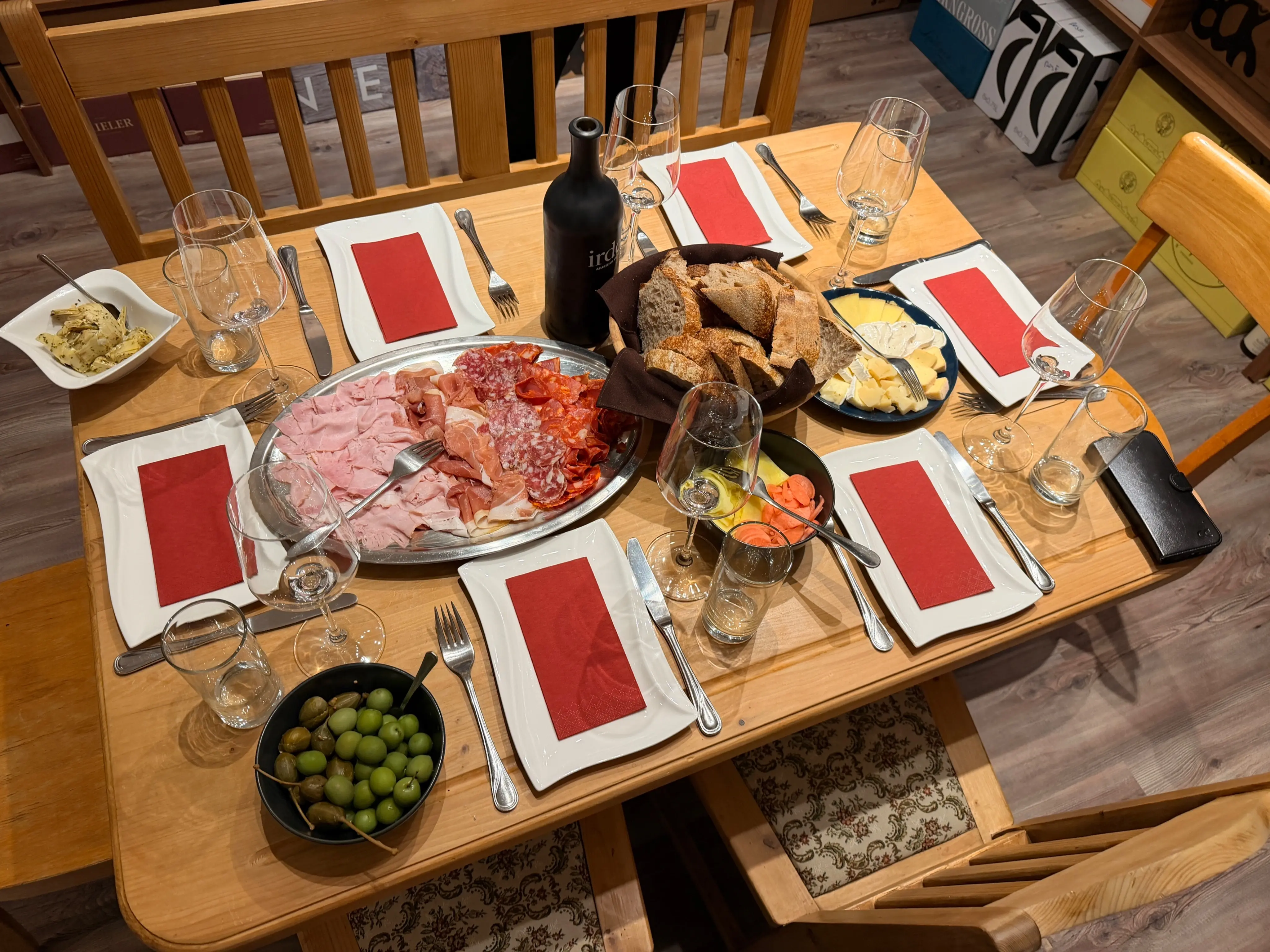Table spread with Austrian wine, cured meats, cheese, and bread at a Vienna wine tasting